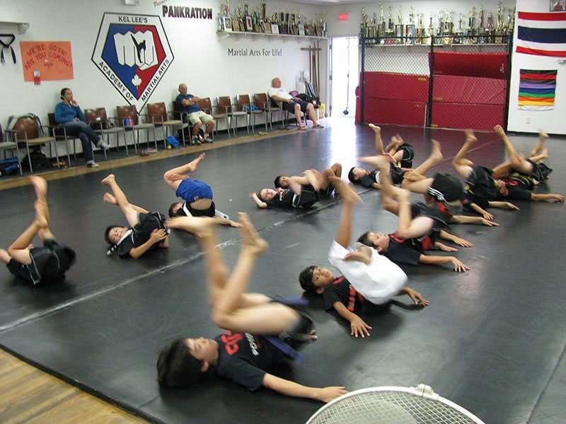 group of kids doing reverse bicycle for martial arts classes in Vancouver